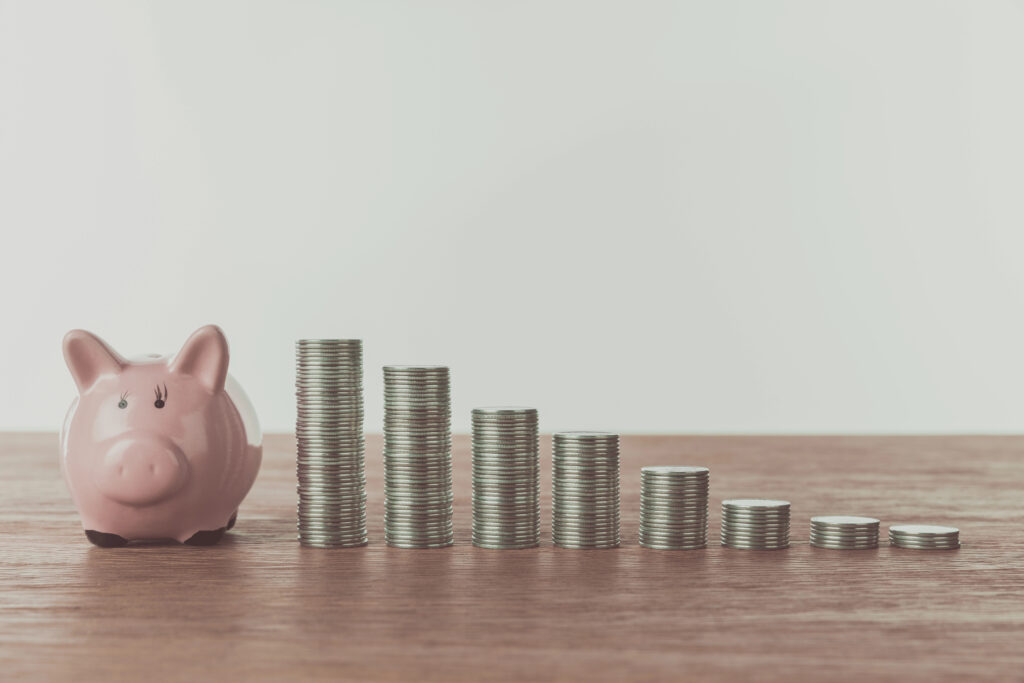 A piggy bank with coins representing outdated budgeting strategies like the 50/30/20 rule.